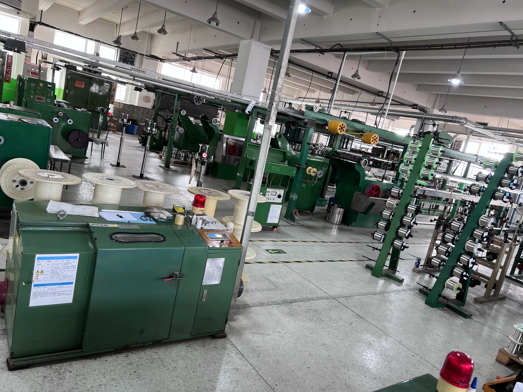 Cable spools and manufacturing equipment inside the MTTJ Tianjin workshop