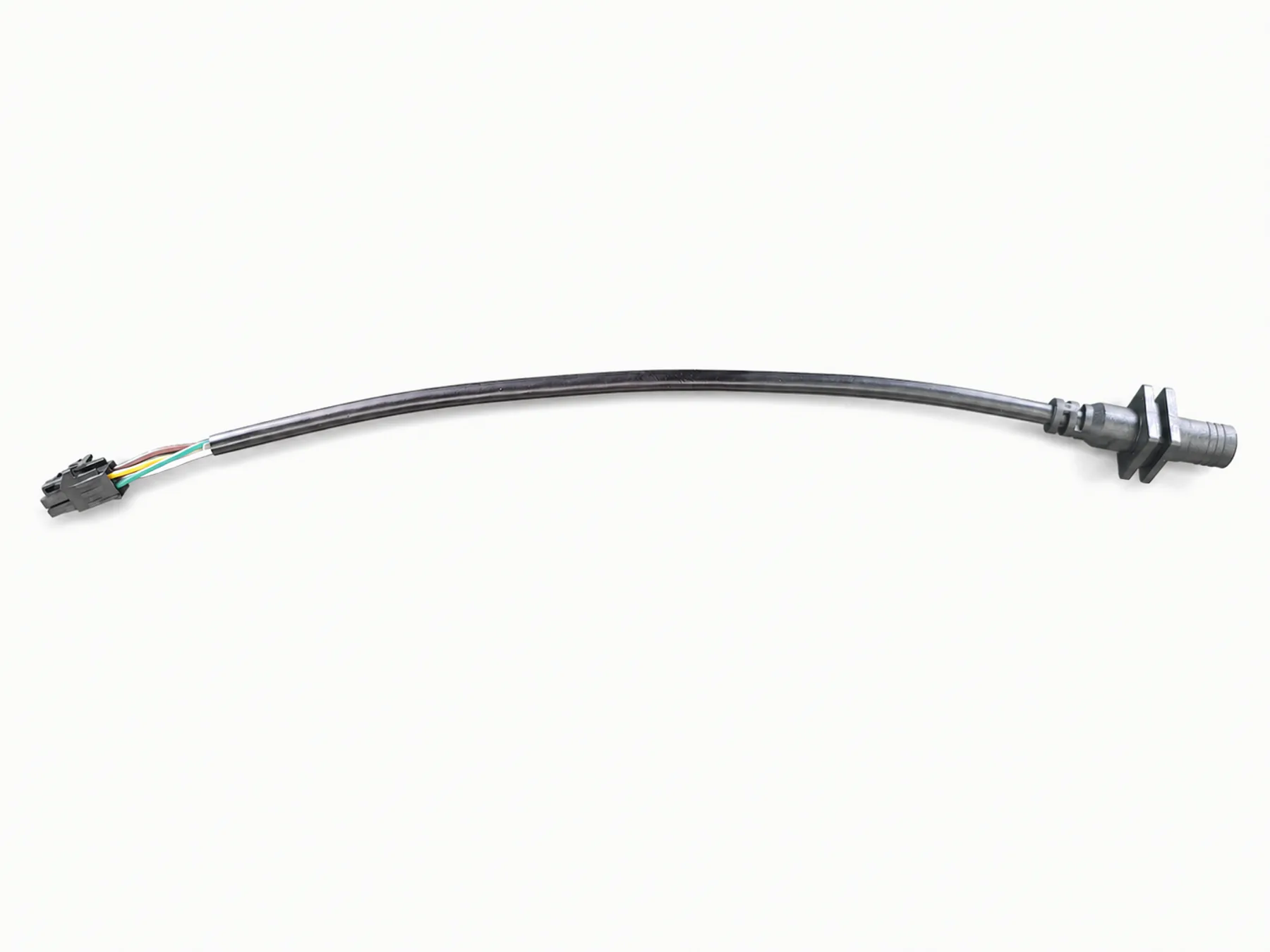 Kurzes schwarzes Kabel mit weißem Kontaktgehäuse und angeformtem Steckverbinder vor warmweißem Hintergrund